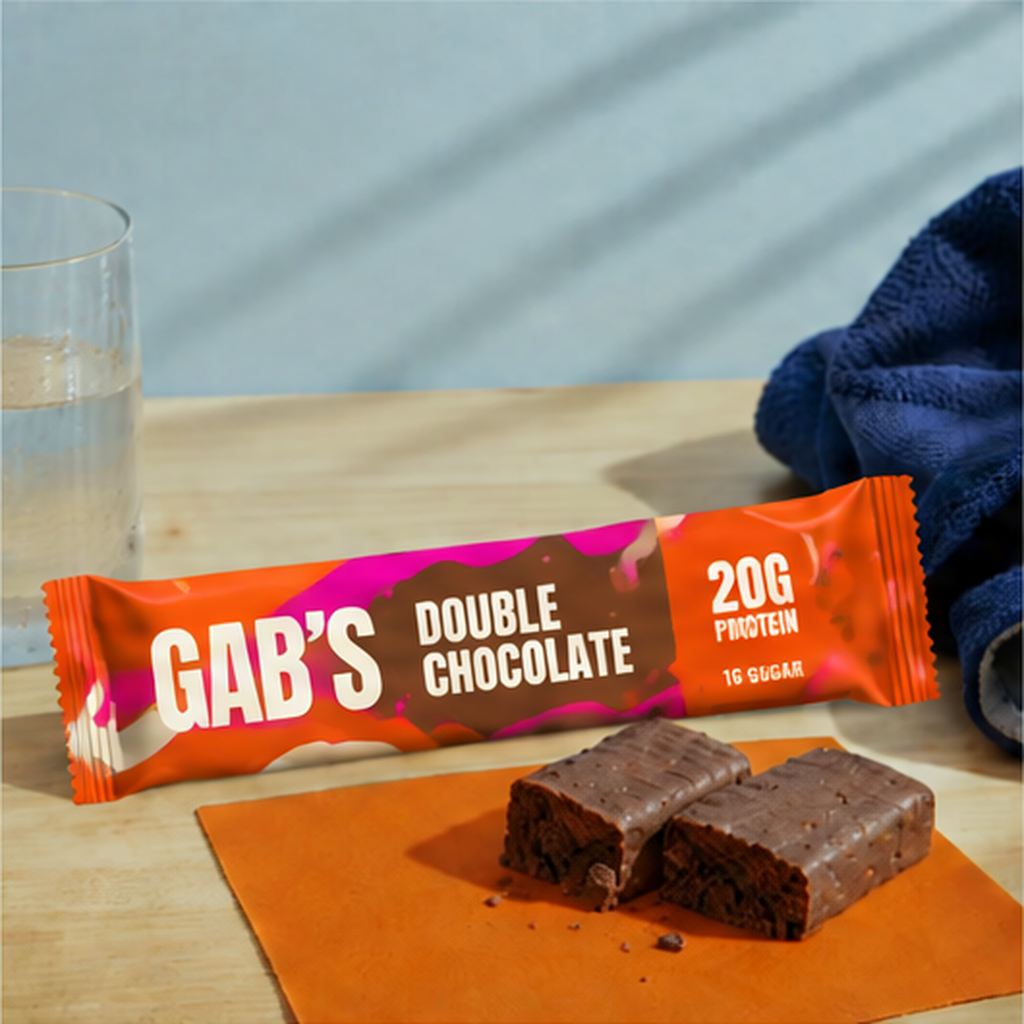 Gab’s Double Chocolate protein bar in bright tangerine and magenta packaging